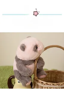 Close-up of a plush baby panda doll with soft pink and grey faux fur in a cozy setting