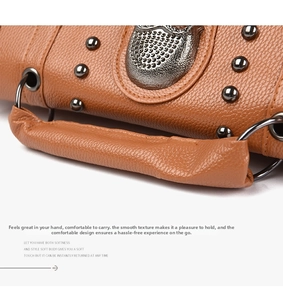Detailed macro view of the vintage brown lychee leather handle with metal rivet accents