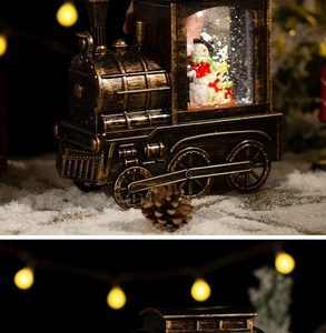 Vintage bronze Christmas train lantern with snowman inside and warm festive lights bokeh