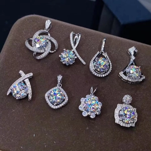 Macro shot of Moissanite diamond pendants in various shapes on a brown velvet pad