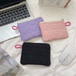 Quilted mini pouches in purple, pink, and black colors for sanitary pad storage