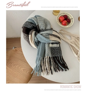 Detail showing soft plaid knit scarf texture with fringe tassels and woven brand label