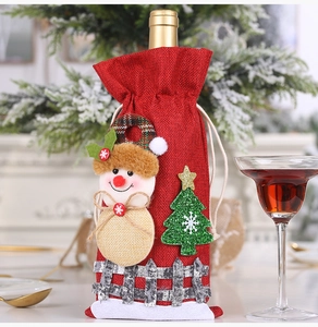 Detailed view of red burlap wine bottle cover featuring festive 3D snowman and fence decor