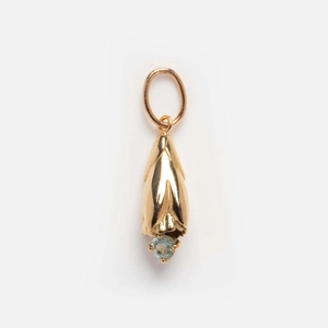 Detailed close-up of a gold-plated flower bud pendant with a light blue birthstone crystal