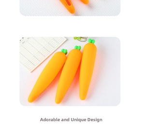 Close-up of bright orange carrot-shaped silicone pencil case with green leaf zipper detail