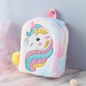 Detailed close-up of rainbow plush unicorn backpack with glittery embroidery and fur ball