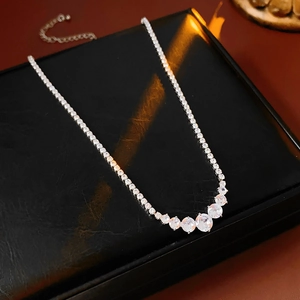 Detail of silver zirconia necklace with gradient stones and lobster clasp on black box
