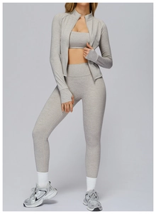 Detail of grey athletic 3-piece set featuring thumbhole cuffs and zip jacket