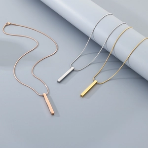 Polished stainless steel bar necklaces in gold, silver, and rose gold on a blue stand