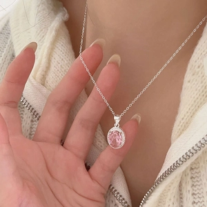 Elegant 925 sterling silver necklace with pink oval zircon pendant worn on neck