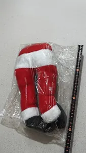 Detailed view of plush Santa elf legs Christmas decoration with measurement ruler