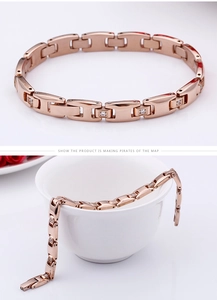Detail of rose gold link bracelet with square-cut zirconia inlay on white background