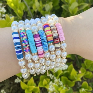 Bohemian stacked bracelet set with colorful Heishi clay beads and white faux pearls