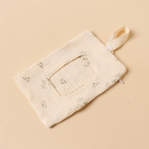 Close-up of cotton baby bed hanging bag with green leaf pattern and snap strap details