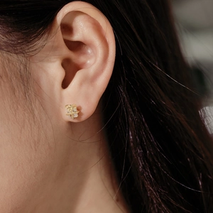 Close-up of gold-plated S925 sterling silver bow earrings with sparkling cubic zirconia