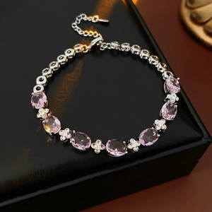 Detail of pink zircon flower bracelet on black leather jewelry box background