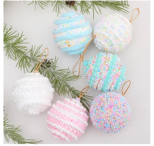 Close-up of 8cm macaron foam Christmas balls with glitter and beads on pine branch