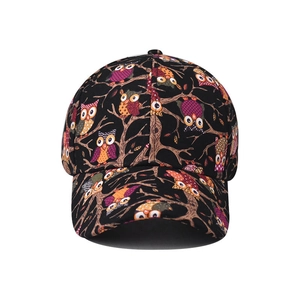 Detail of black baseball cap with colorful owl pattern print and six-panel cotton structure