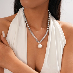 Elegant necklace with zircon beads and large white pearl pendant worn by model