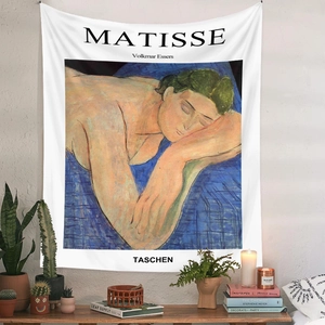 Artistic Matisse style tapestry on white wall with modern home decor accessories