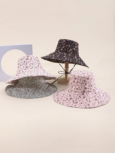 Detail view of four patterned reversible sun hats with wide brims and floral prints