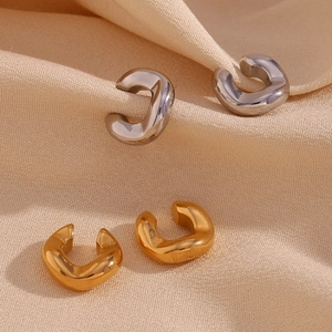 Polished C-shape thick ear cuffs in gold and silver finish on elegant beige silk fabric