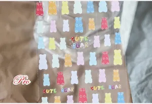 Detail of colorful transparent gummy bear nail stickers with Cute Bear art text