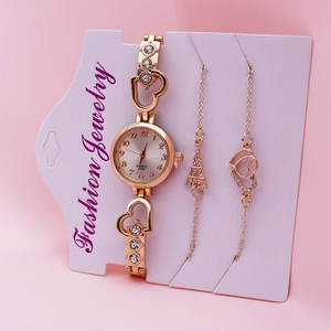 Elegant rose gold women's quartz watch and heart charm bracelet set on pink background