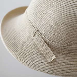 Hepburn style beige straw sun hat with fine spiral weave and golden metallic detail