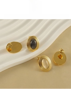 Detail of 18K gold-plated oval stud earrings with natural stone and lead-free material