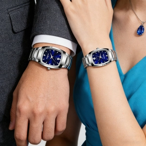 Elegant pair of square quartz watches with deep blue dials and silver metal straps