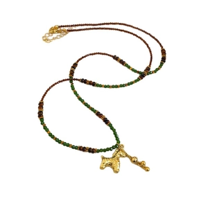 Green and brown beaded necklace with a golden poodle pendant and adjustable chain