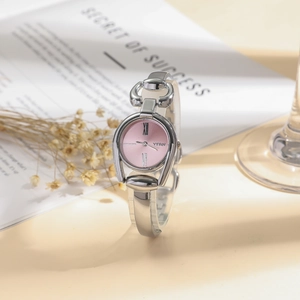 Elegant silver bracelet watch for women with pink Roman dial on a lifestyle background