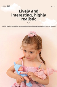 Girl holding two realistic 8-inch reborn baby dolls in blue and pink knitted outfits