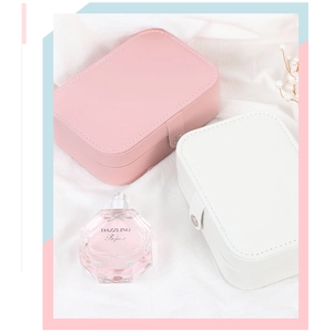 Detail of portable pink and white leather jewelry boxes with snap closure and soft lining