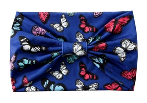 Detail of blue stretch yoga headband with vibrant red and pink butterfly print pattern