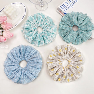 Set of four floral and striped oversized scrunchies in elegant pastel blue and beige