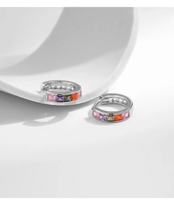 Macro detail of silver S925 hoop earrings with multi-colored square zircon stones