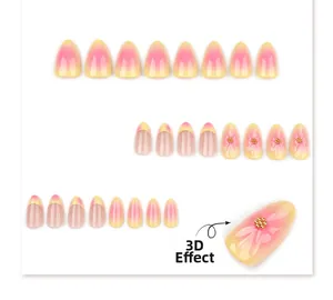 Macro view of 3D embossed flowers and gold beads on pink and yellow gradient almond press-on nails