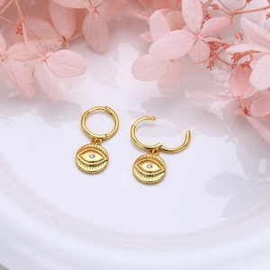 Detailed close-up of golden S925 silver evil eye hoop earrings with cubic zirconia