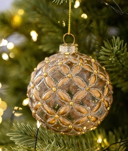 Detail of 8cm glass Christmas ball hanging on tree with golden glitter patterns