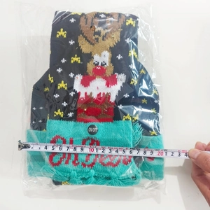 Detail of Christmas knitted scarf with LED lights and elk pattern showing 24cm width measurement