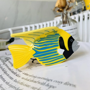 Macro detail of tropical fish hair claw clip made of polished yellow and blue acetate