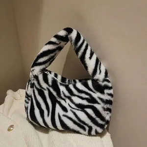 Faux fur handbag with black and white zebra print and top handle for autumn winter