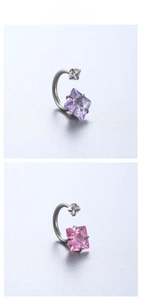 Close-up of titanium steel horseshoe ring with purple and pink square cubic zirconia stones