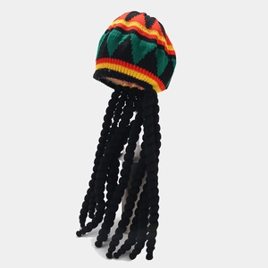 Close-up of Rasta style knit hat with black faux wig braids and red yellow green pattern
