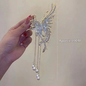 Detail of 19cm butterfly hair claw with gold metal frame, rhinestones and pearl tassels