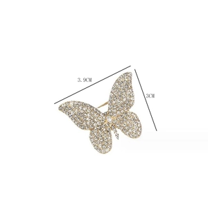 Detail showing crystal butterfly brooch measurements of 3.9cm by 3.0cm on white background