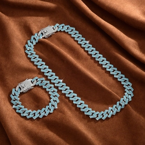 Detailed view of silver-toned 15mm Cuban link chain and bracelet set with blue rhinestones