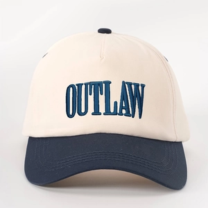 Detail of high-density twill cotton baseball cap with OUTLAW embroidery and contrast brim